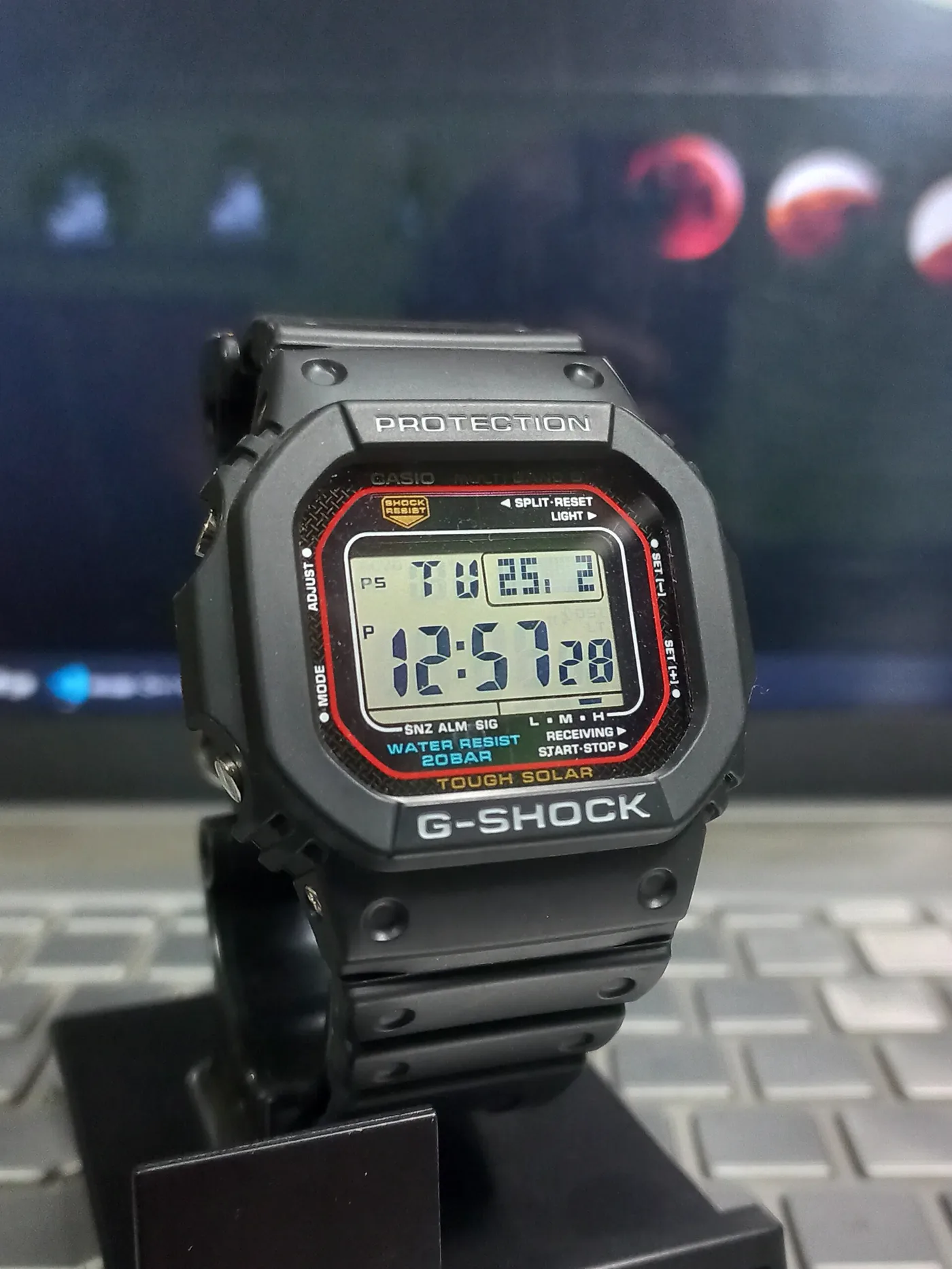 Black resin Casio G-Shock GW-M5610U digital watch on display stand, Tough Solar dial visible