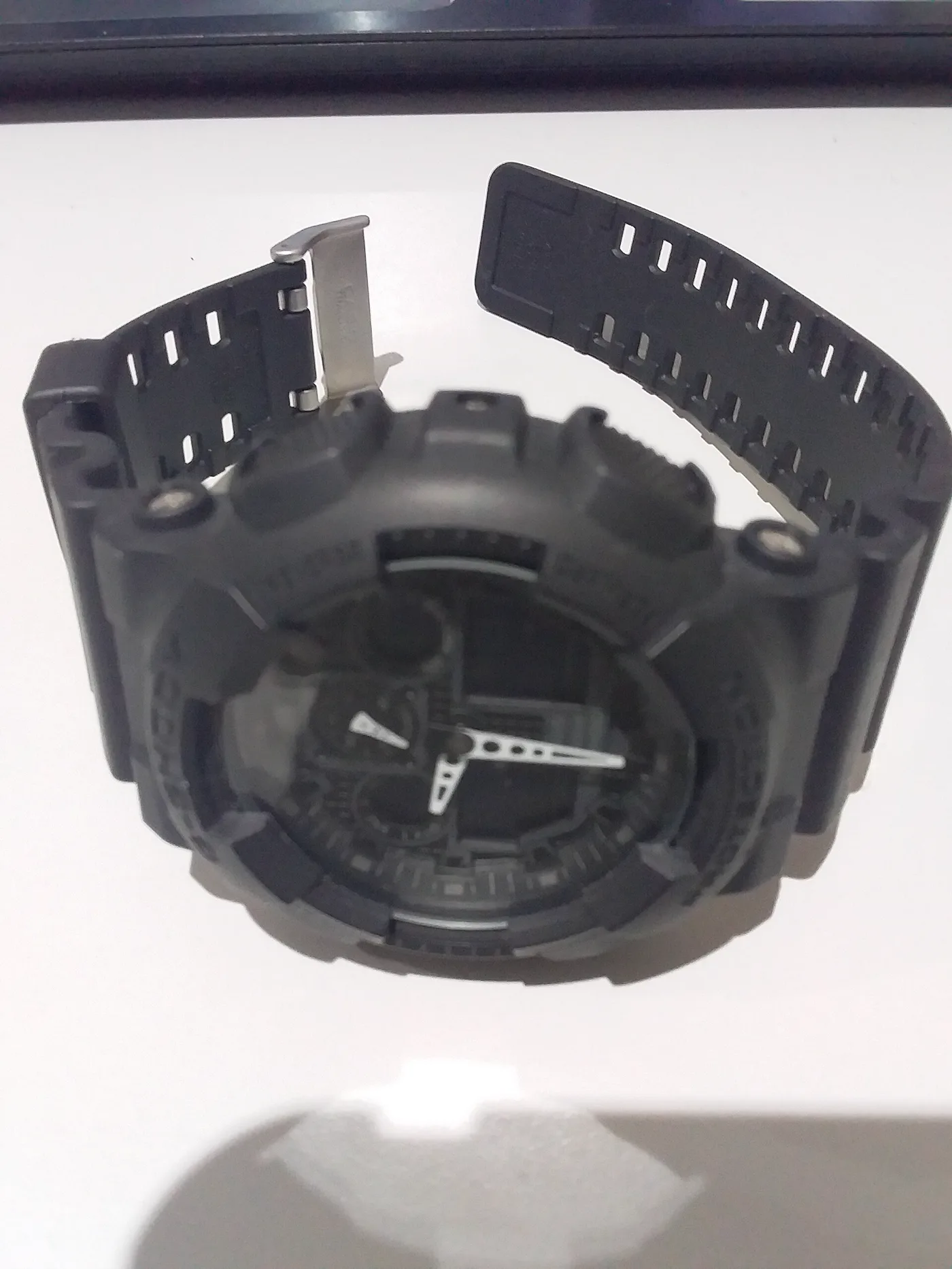 Black Casio G-Shock GA-2100 CasiOak watch, resin band unclasped, shown upside down