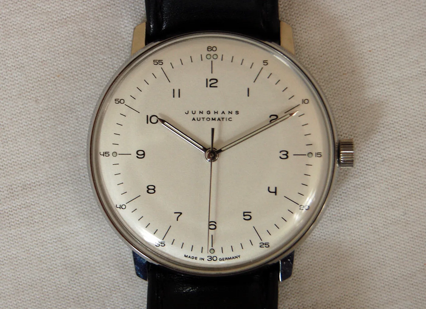 Close-up of Junghans max bill Automatic watch with cream dial and black leather strap