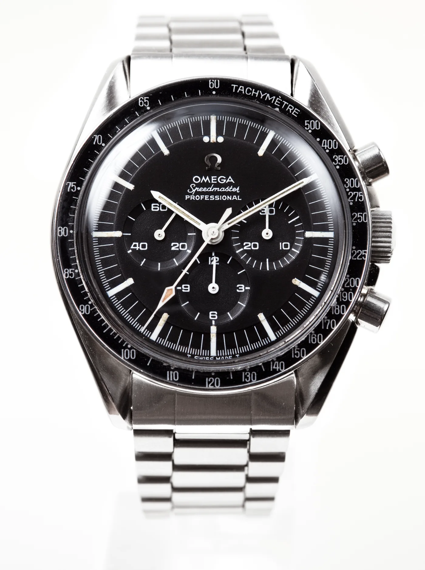 Omega Speedmaster Professional chronograph, black dial, steel bracelet, tachymeter bezel, studio product photo.