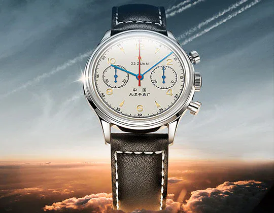 Seagull 1963 chronograph, cream dial, steel case, black leather strap, sky backdrop
