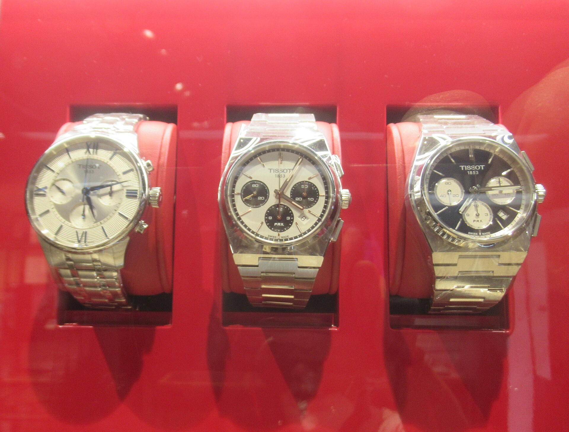 Three Tissot PRX watches with integrated steel bracelets